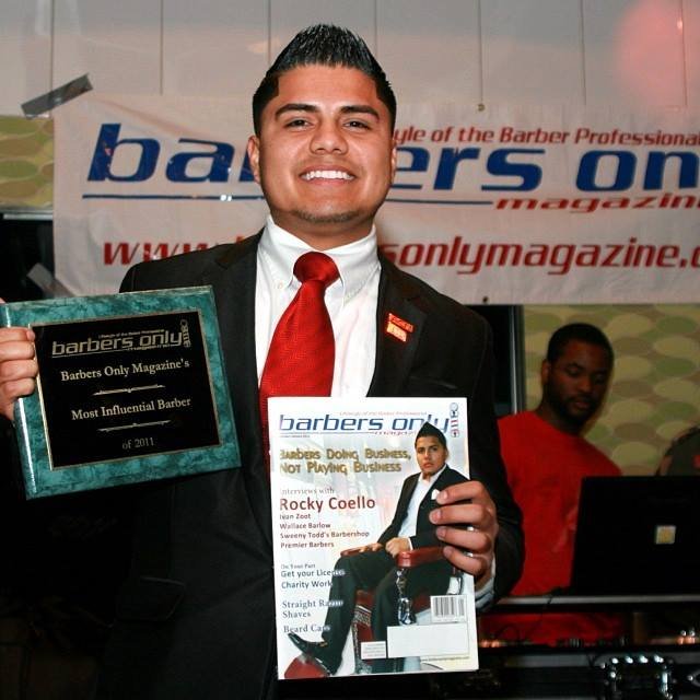 Juan Coello holding Barbers Only Magazine award and cover